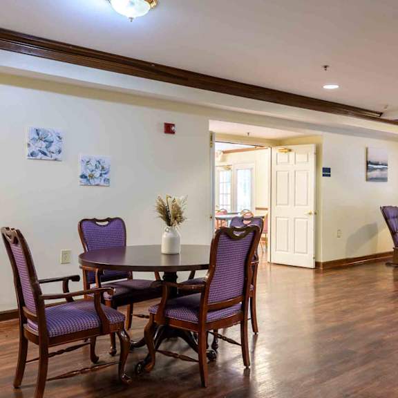 a dining room with a table and chairs.