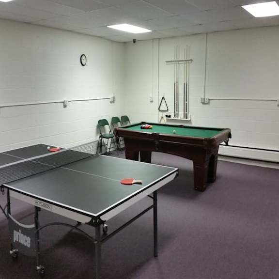 a pool table and ping pong table in a room.