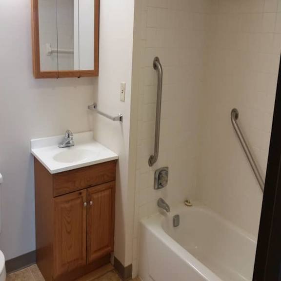 a white toilet sits next to a sink in a small bathroom.