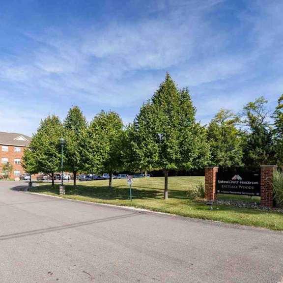 a parking lot in front of a brick building with a sign that reads "bridgewater".