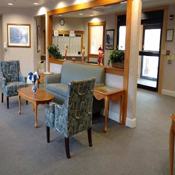 a waiting room with two chairs and a sofa.