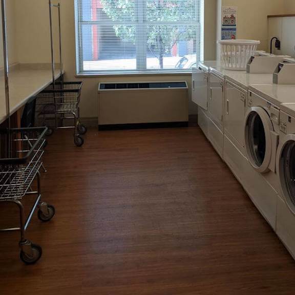 a laundromat with a row of washers and dryers.