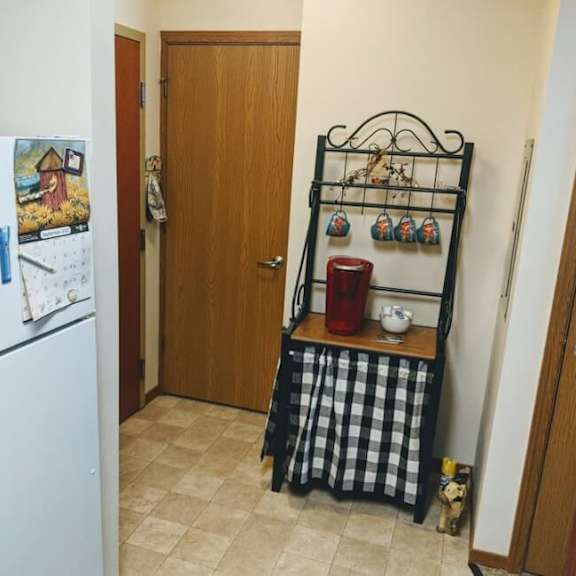 a kitchen with a white fridge and a black and white checkered tablecloth.
