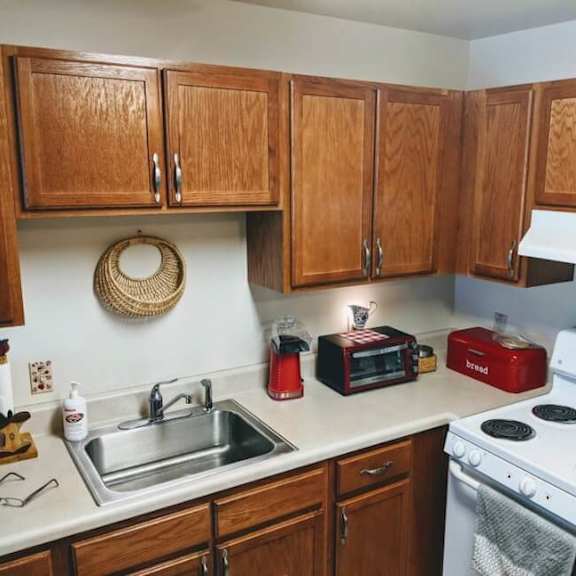 a kitchen with wooden cabinets and a white stove.