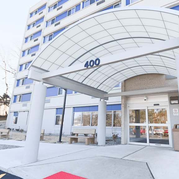 a white building with a glass entrance and a canopy with the number 400 on it.