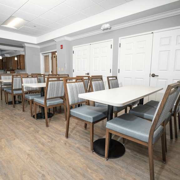 a room with a long table and chairs.