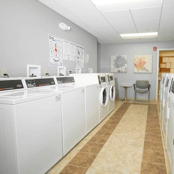 a laundromat with rows of washers and dryers.