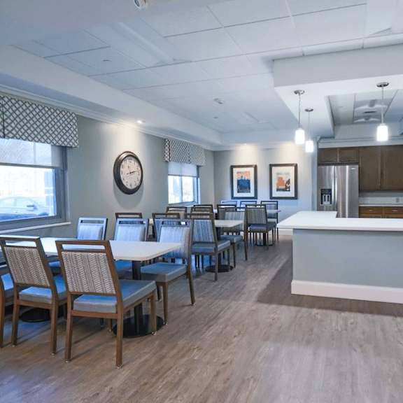 a dining room with a long table and chairs.