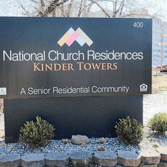 a sign for national church residences kinder towers, a senior residential community.