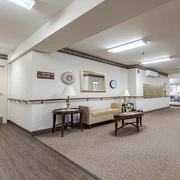 a spacious waiting room with a couch, chairs, and a coffee table.
