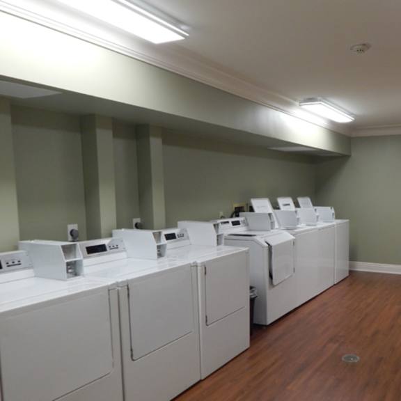 a laundry room with washers and dryers.