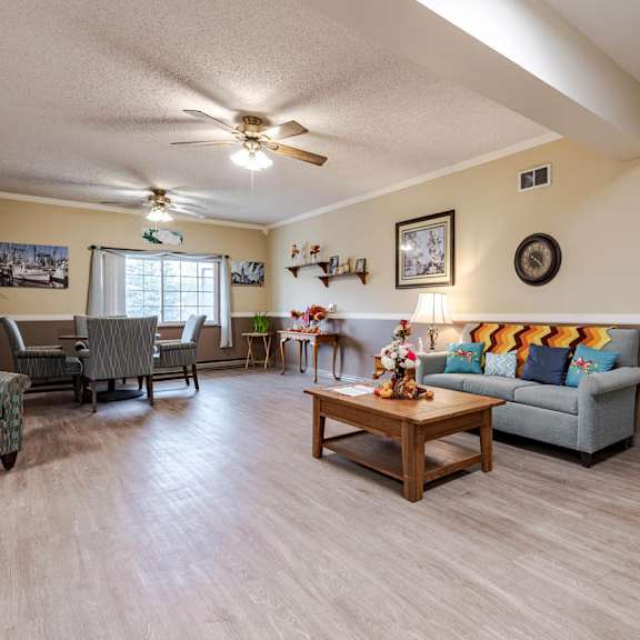 a living room with a grey couch and a wooden coffee table.