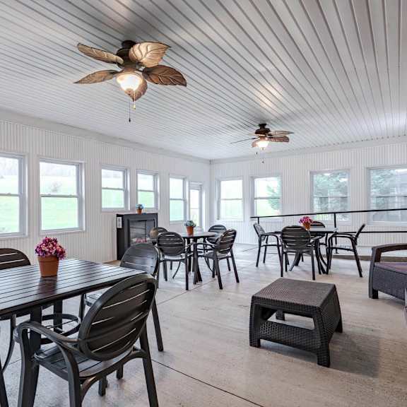 a sunroom with a table and chairs.