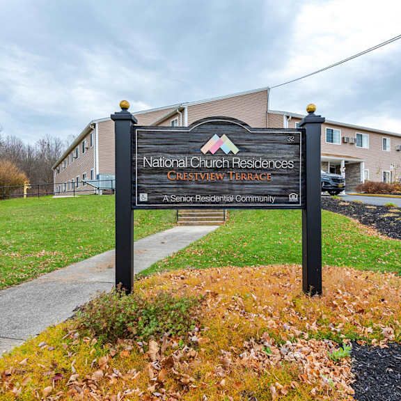a sign for national church residences is displayed in front of a building.