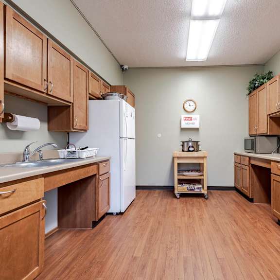 a kitchen with wooden cabinets and a white refrigerator.