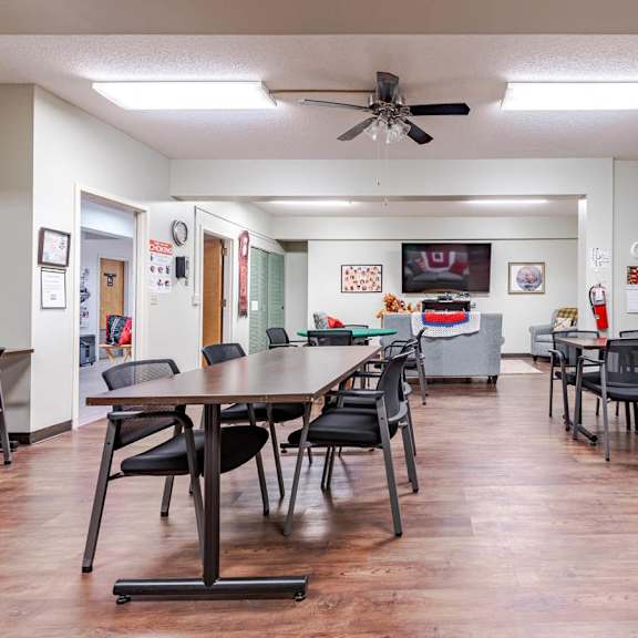 a room with a long table and chairs.