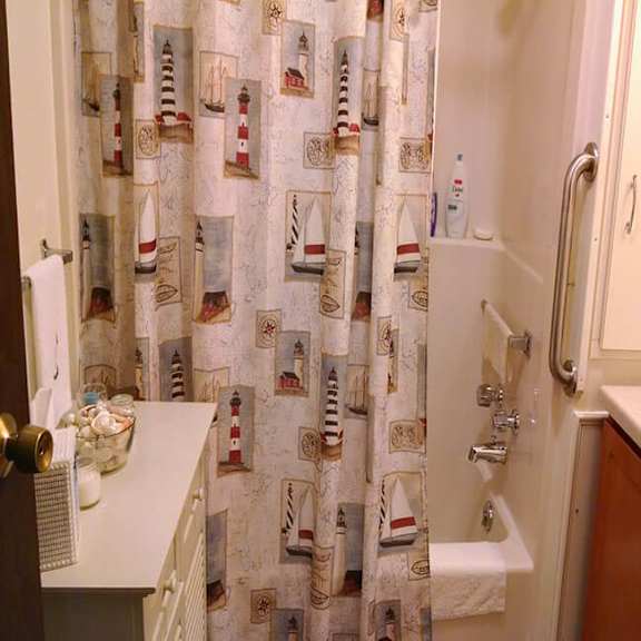 a shower curtain with lighthouses on it.