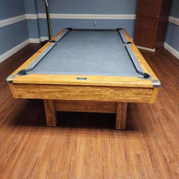 a pool table in a room with blue walls.