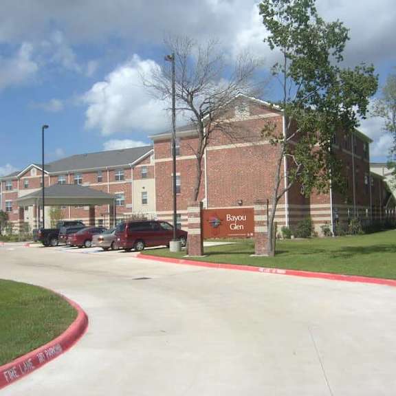 a red brick building with a sign that says bayou glen.
