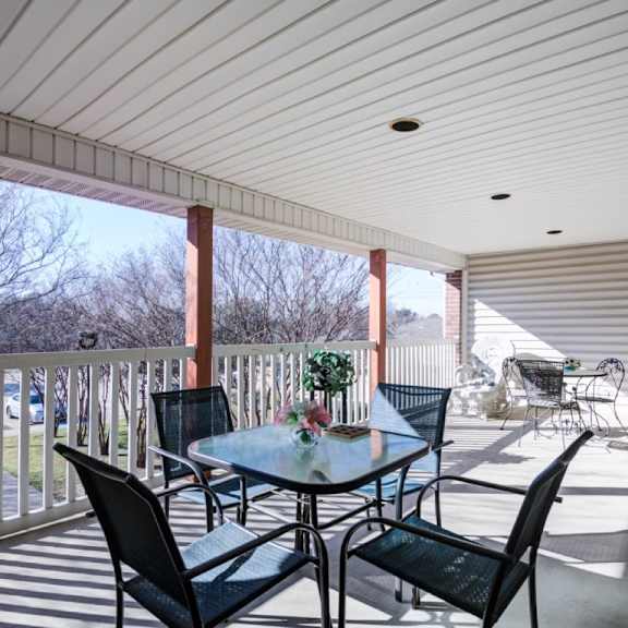 a patio with a table and chairs is shown.