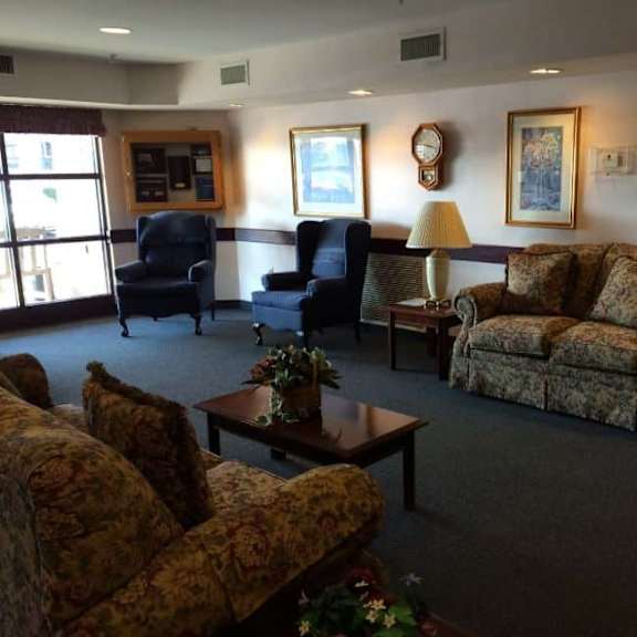 a living room with a sofa, two chairs, and a coffee table.