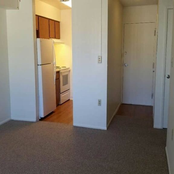 a kitchen area with a refrigerator, microwave, and oven.