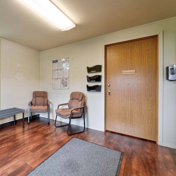 a waiting room with two chairs and a table.