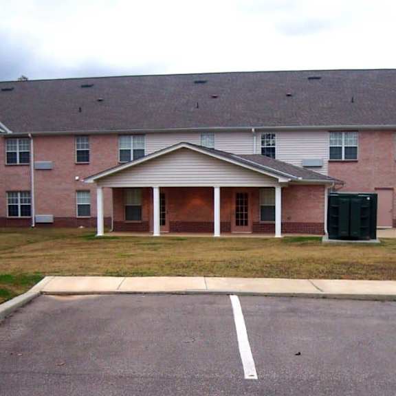 a brick building with a covered walkway.