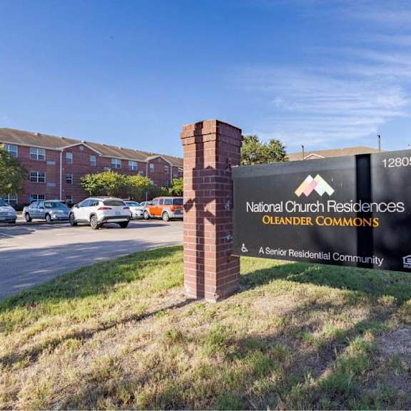 the sign in front of the brick wall reads "national cut residential commons oleaner commons".