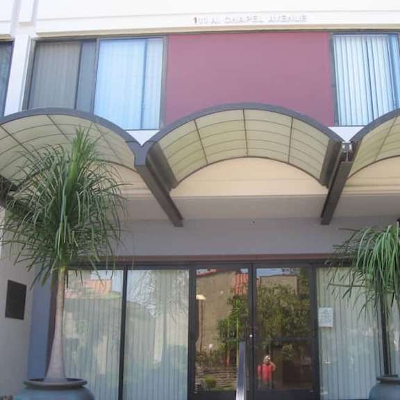 a building with a red wall and a glass door.