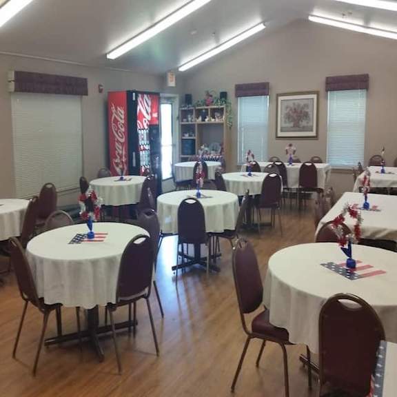a room with tables and chairs set up for an event.