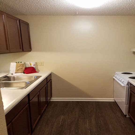 a kitchen with brown cabinets and white appliances.