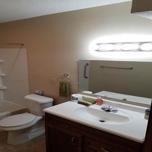 a bathroom with a toilet, sink, and bathtub.