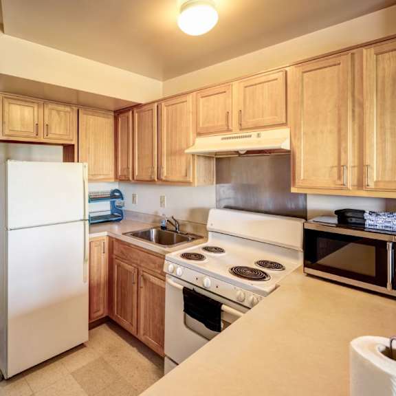 a kitchen with wooden cabinets and a white refrigerator.