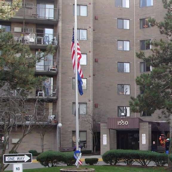 a large apartment building with a flag flying in front of it.