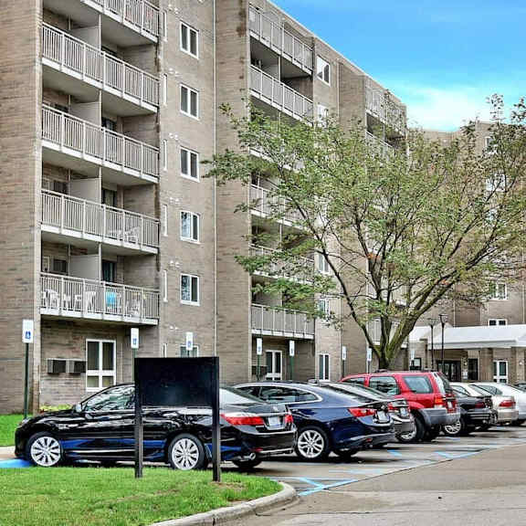 a parking lot in front of apartment buildings.