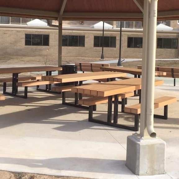 a covered outdoor picnic area with tables and benches.