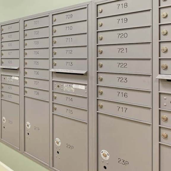a row of mailboxes are lined up against a wall.