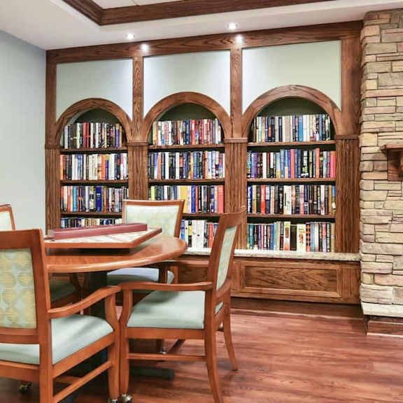 a room with a fireplace and a bookshelf filled with books.