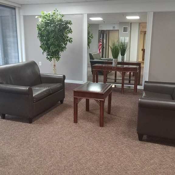 a living room with a sofa, armchair, and coffee table.