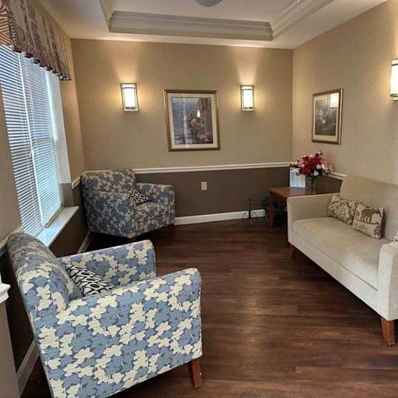 a living room with a sofa, two chairs, and a coffee table.