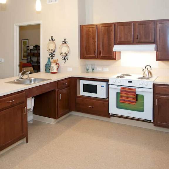 a kitchen with brown cabinets and a white countertop.