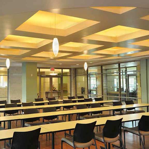 a conference room with tables and chairs and a ceiling with lights.