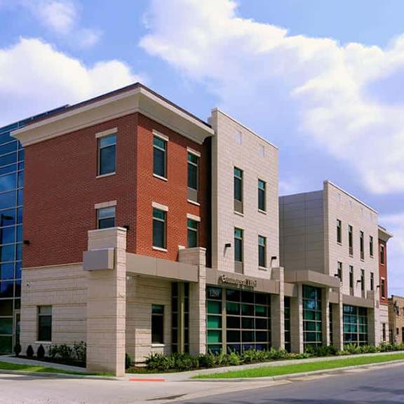a modern building with a combination of brick and glass facade.