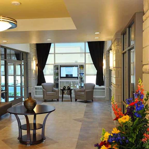a modern living room with a glass door and a flat screen tv.