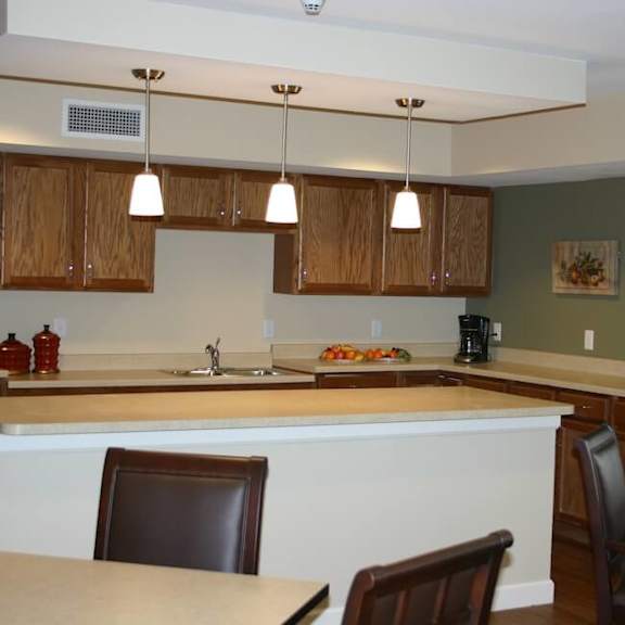 a kitchen with brown cabinets and a white counter.