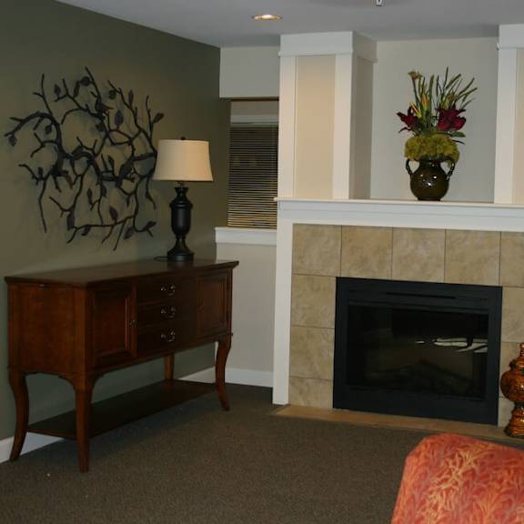 a fireplace with a vase of flowers on top of it.