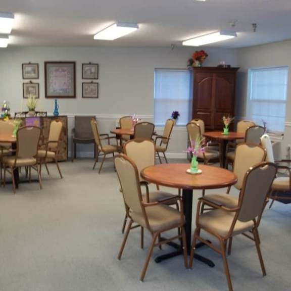 a room with a table and chairs set up for a meeting.