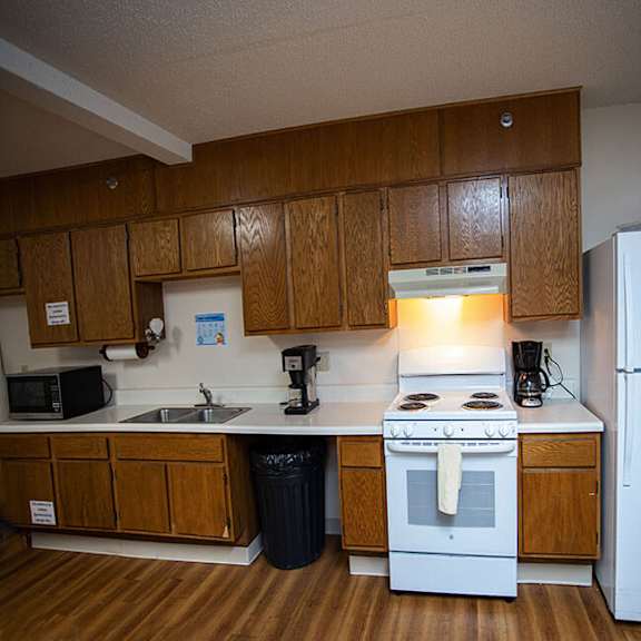 a kitchen with a white stove and refrigerator.