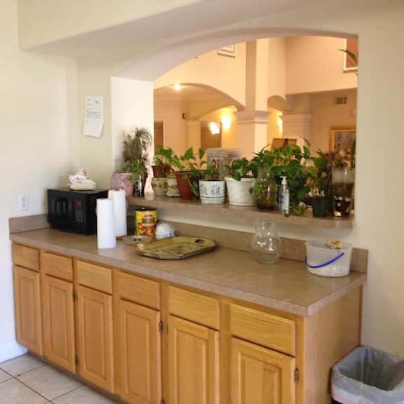 a kitchen with wooden cabinets and a countertop with various items on it.